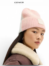 Load image into Gallery viewer, NWT COACH Colorblock Beanie With Rubber Patch. Peach/Chalk
